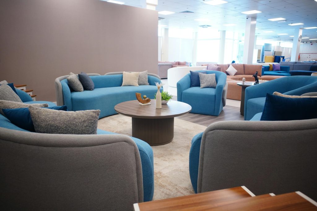 Contemporary lounge area with blue sofas and chic decor in a stylish setting.